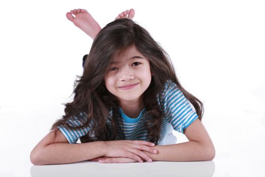 Beautiful seven year old girl lying on floor, biracial asian - scandinavian descent