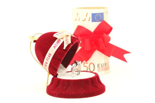 xmas gift box with white gold ring and euro money background isolated