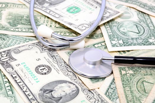 expensive health treatment stethoscope on dollar background