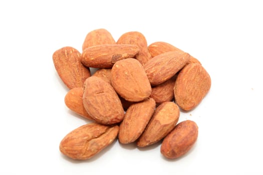 closeup almond nuts rasted and salted isolated on white background