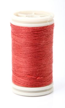 closeup of red sewing cotton string isolated