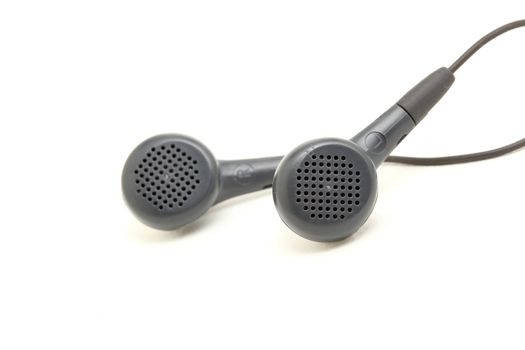 small black streophonic earphones closeup isolated on white background