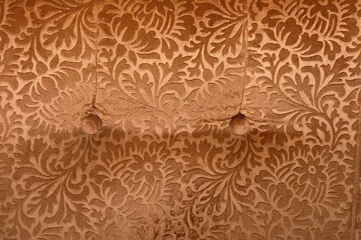 abstract retro golden velvet textile detail with butons from couch