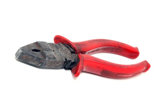 old used plier with red rubber handle isolated