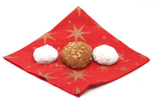 two traditional Greek Christmas sweets  melomakarona and kourampie on red paper napkin