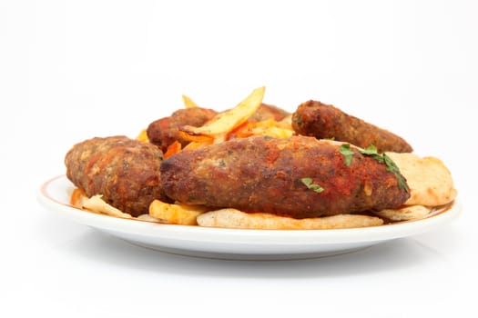 plate with fried potatos and four stakes isolated on white background