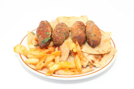 plate with fried potatos and four stakes isolated on white background