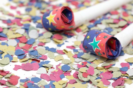 detail blowers on confetti background party and celebration