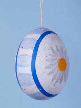 handpainted easter egg over blue