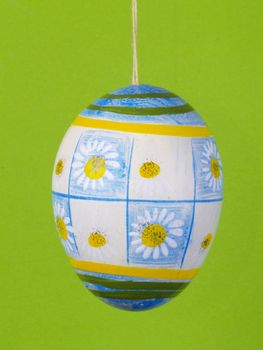 handpainted easter egg over green