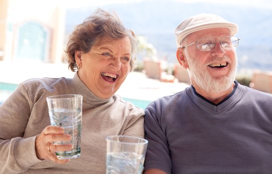 Happy Senior Adult Couple Enjoying Drinks Together.