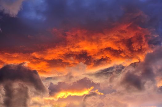 A jumble of stratocumulus clouds at sunset. Suitable as an abstract, natural graphics background.