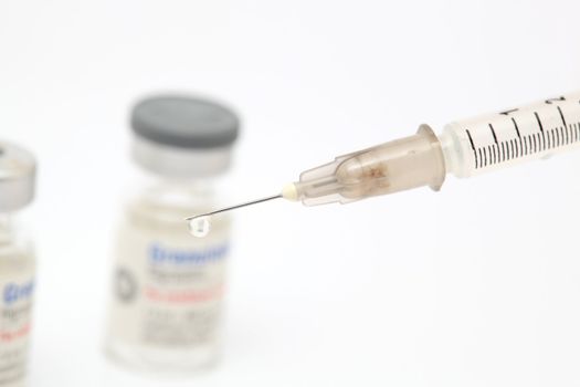 drug drop and syringe closeup detail on white background