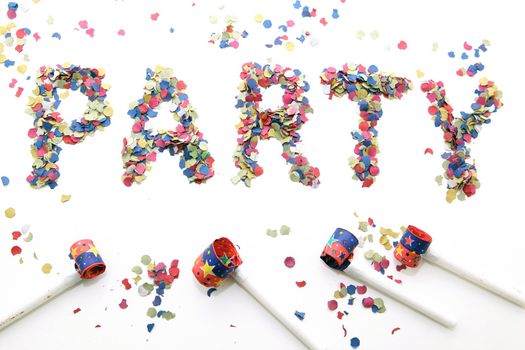 party word with confetti and blowers on white background