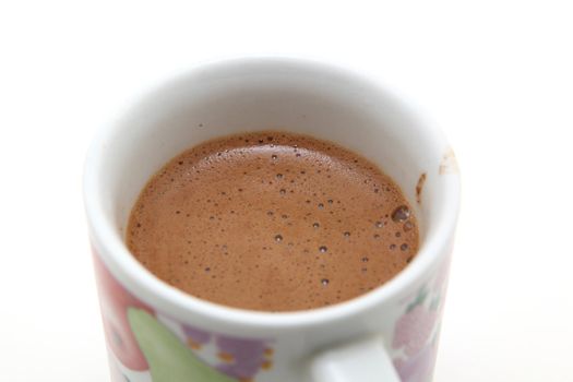 mug with greek coffee detail with bubbles on white background