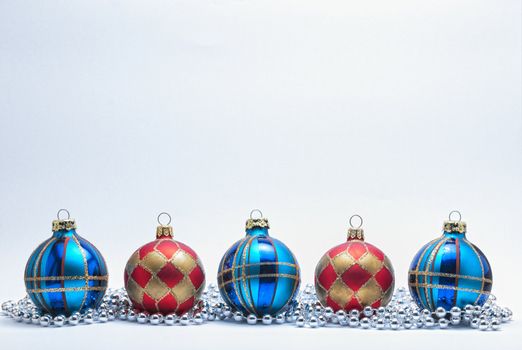 Christmas Baubles with silver beads on a white background.