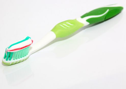 one toothbrush with paste on white background