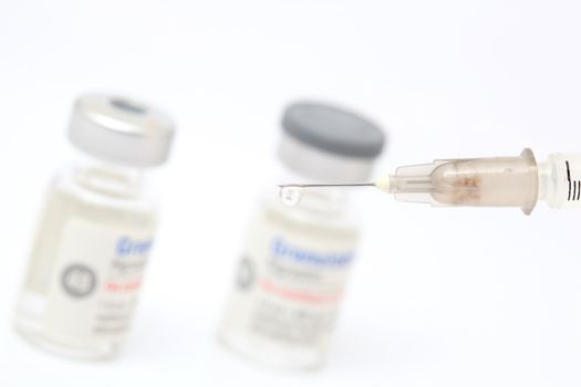 drugs and syringe closeup detail on white background