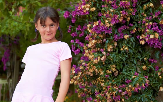 Girl smiling forefront bougainvillea flowers in blossom