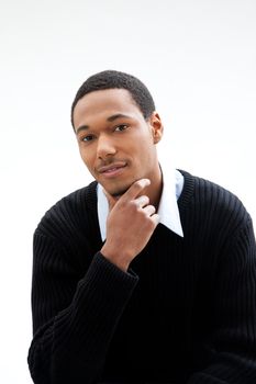 Handsome African American male in blue shirt and black sweater, isolated