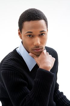 Handsome African American male in blue shirt and black sweater, isolated