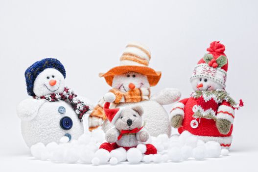 Christmas Teddy with three Snowmen on a white background.