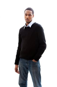 Handsome African American male in blue shirt black sweater and jeans standing, isolated