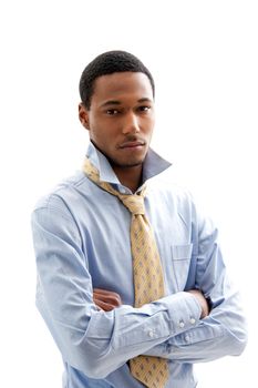 Handsome African American male in blue shirt and yellow tie with arms crossed and collar up, isolated