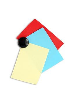 Few colored paper sheets hanging with magnet on white background. Clipping path included