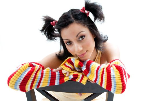 Beautiful fun latina girl with bright colored arm warmers and ponytails with red ribbons in her hair, isolated