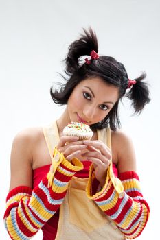 Beautiful Latina girl with huge eyes open holding a cupcake, isolated