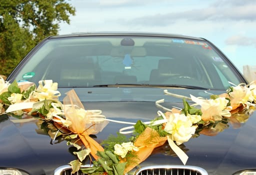 Wedding arangement on blue car