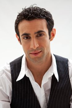 Handsome male wearing a white shirt and black pinstripe vest, isolated