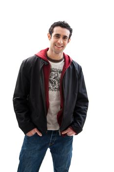 Cool handsome male smiling wearing a red hoodie, black coat and jeans, with hands in pocket, isolated