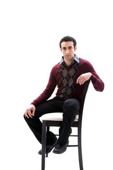 Handsome guy wearing business casual clothes sitting on a high chair, isolated