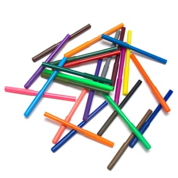 Scattered colored felt tip pens on white background