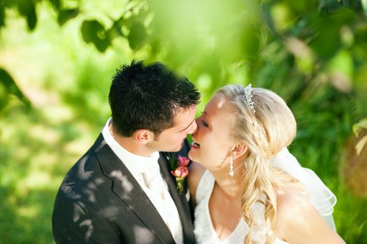 wedding couple hugging and kissing in a private moment of joy