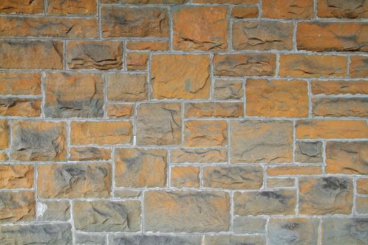 Multi sized rectangular gold and gray stones of a motared wallv