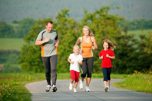Family jogging with two little daughters