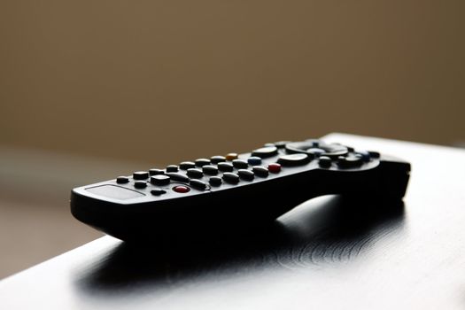 A remote control sitting on table in a living room.
