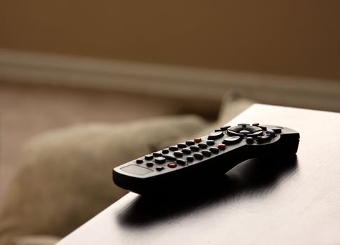 A remote control sitting on table in a living room.