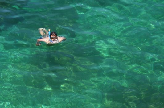 A snorkeler surfacing, in cool waters in Georgian bay.