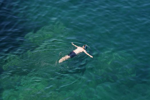 A man snorkeling in the cool waters of Georgian Bay, Ontario, Canada.