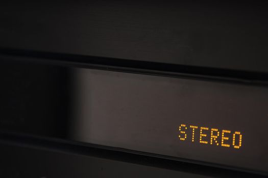 A closeup of a digital display on an amplifier that says stereo.