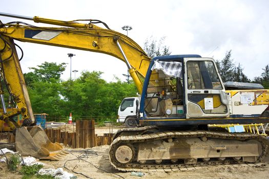 Shovel mud machine and green tree behind