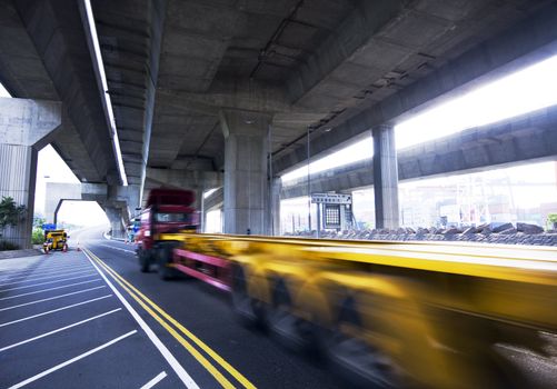 container car fast moving under the freeway bridge