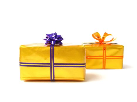 present boxes in gold wrap and colorful belts with bows on  white background 