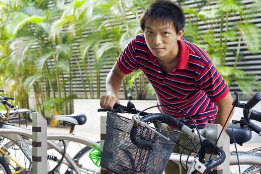 asia man take bike in bicyle park