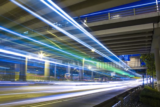 Freeway in night with cars light in modern city. 