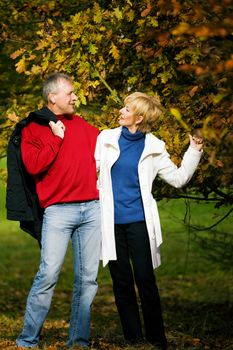 Mature couple deeply in love having a walk holding each other tight